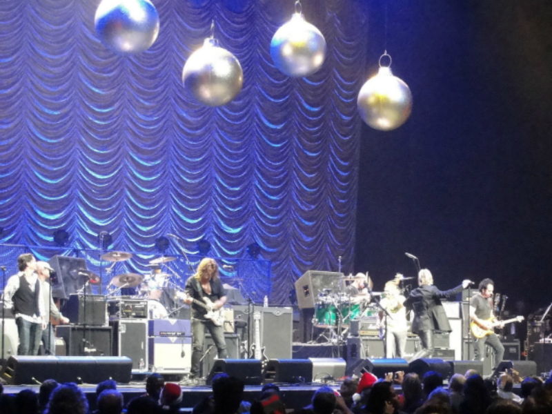 A group of people on stage with christmas ornaments.