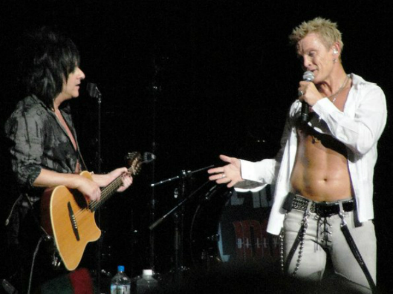 Two men standing next to each other on stage.