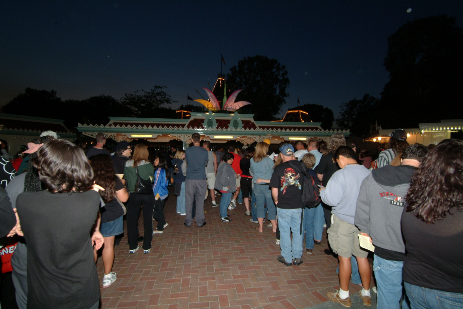 A crowd of people standing around in front of a building.