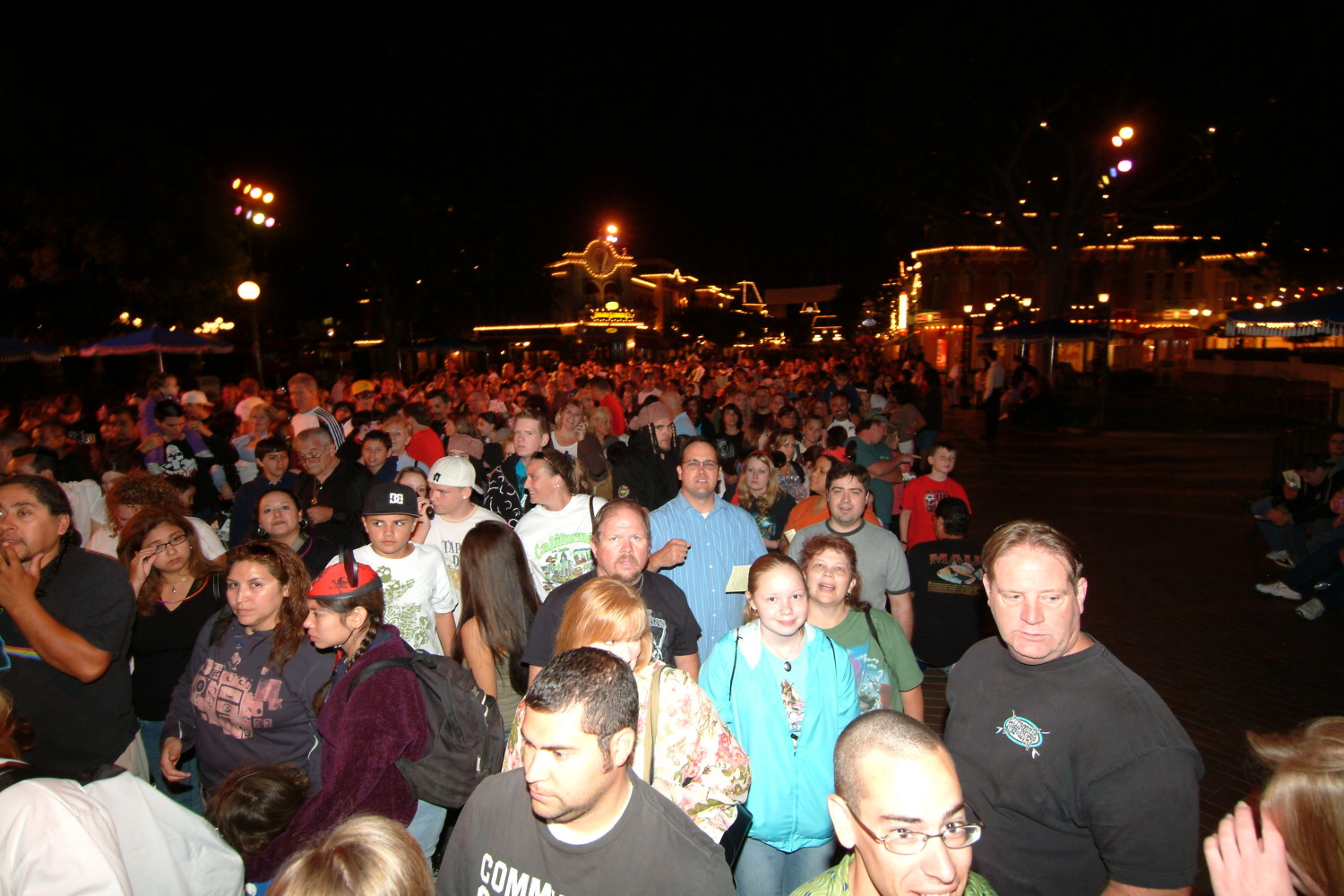 A large crowd of people standing in the dark.
