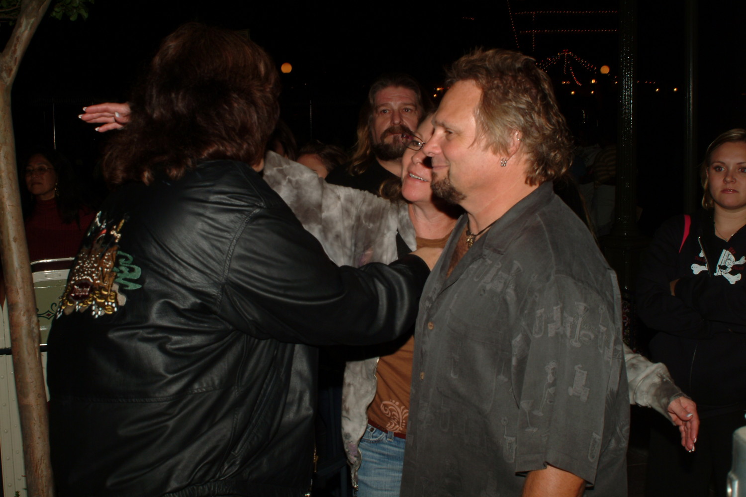 A group of people standing around each other.