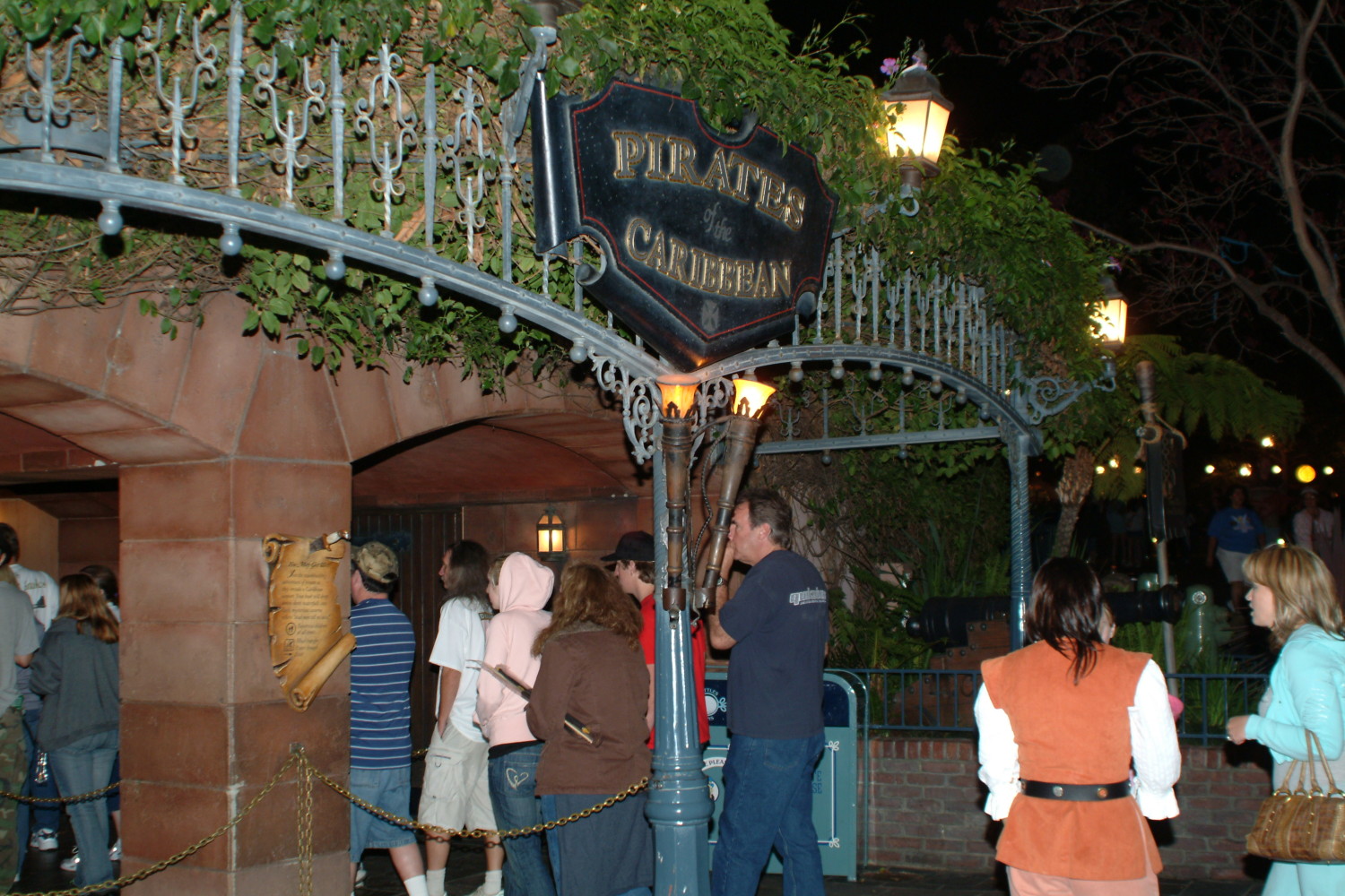 A group of people standing around at night.