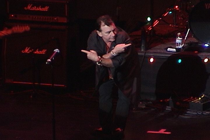 A man standing on stage with a microphone.