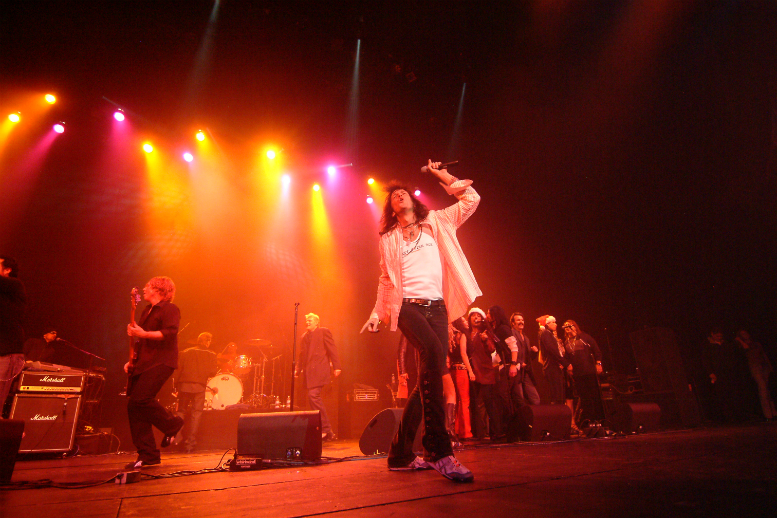 A man is singing on stage.
