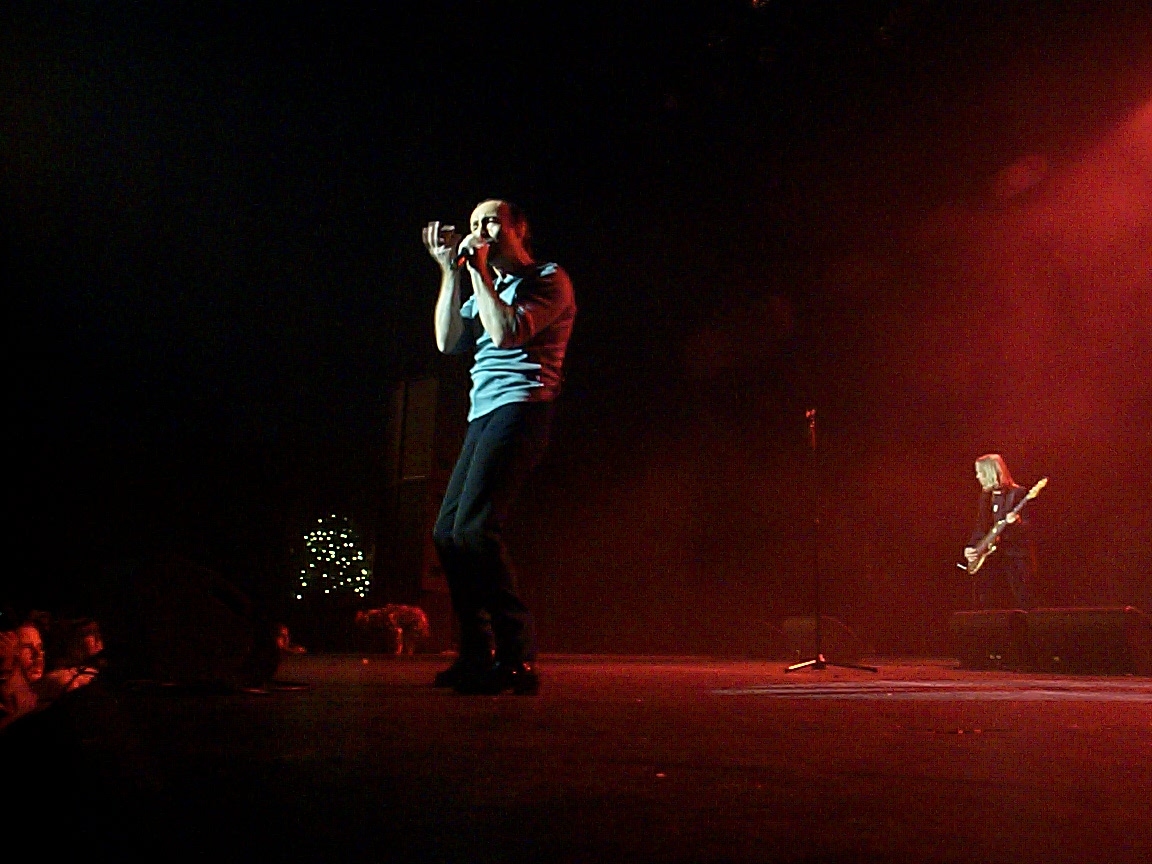 A man is singing on stage.