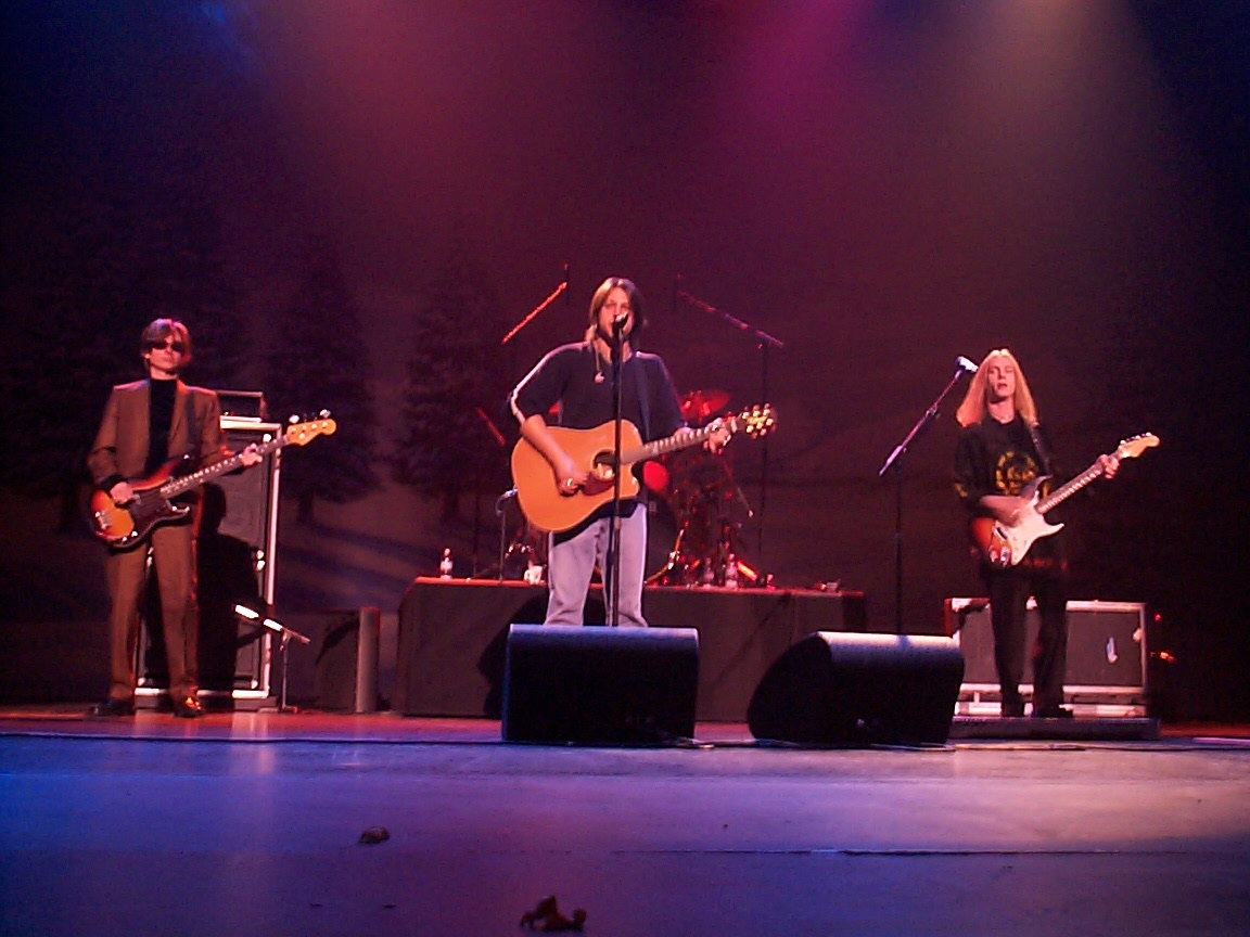 A group of people on stage with guitars.