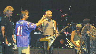 A man holding a guitar.