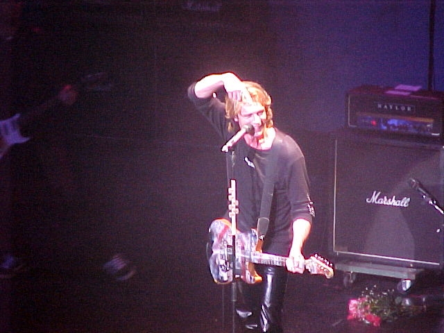 A man with a guitar on stage.