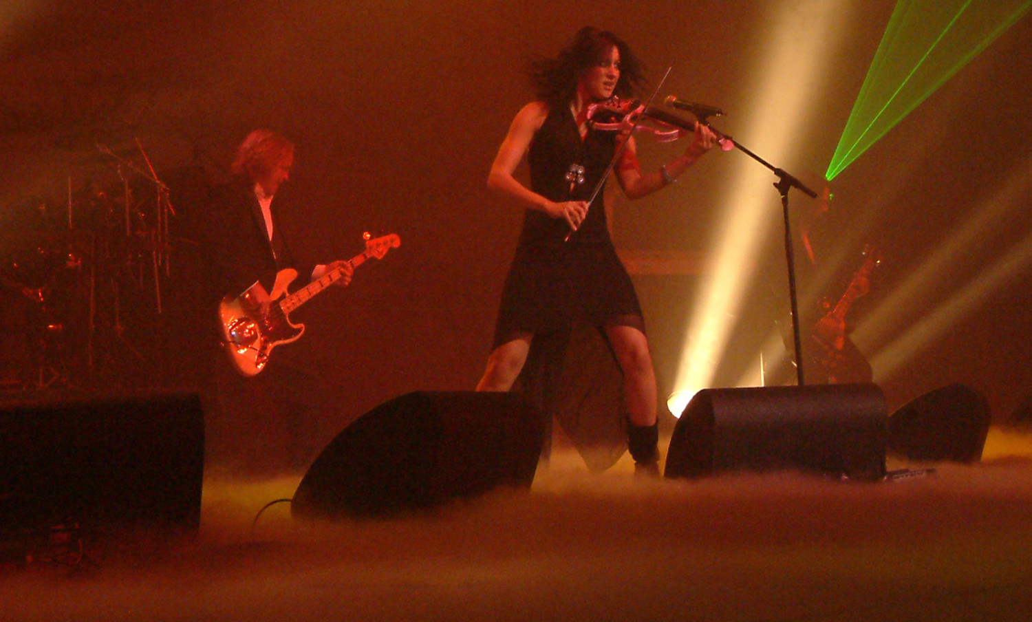 A woman playing a violin on stage.