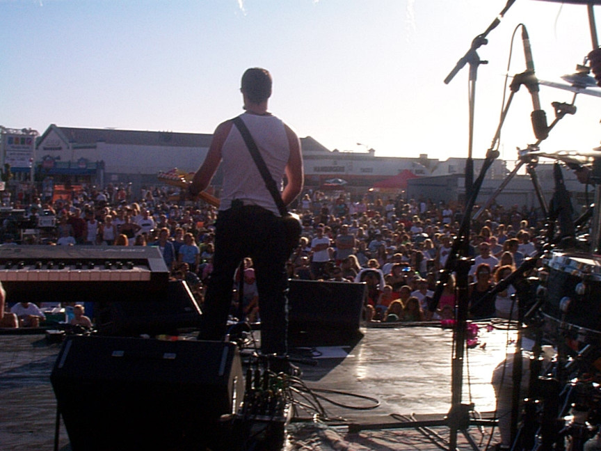 A man standing on a stage in front of a crowd.