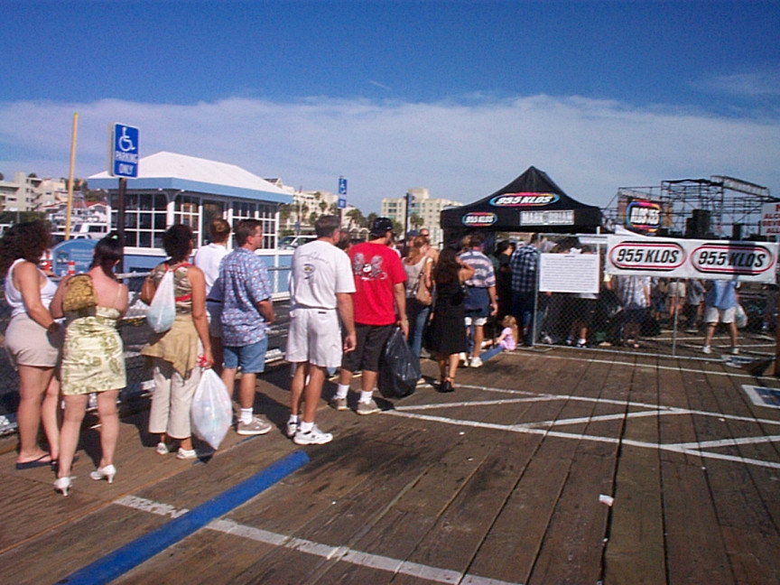 A group of people standing on a pier.