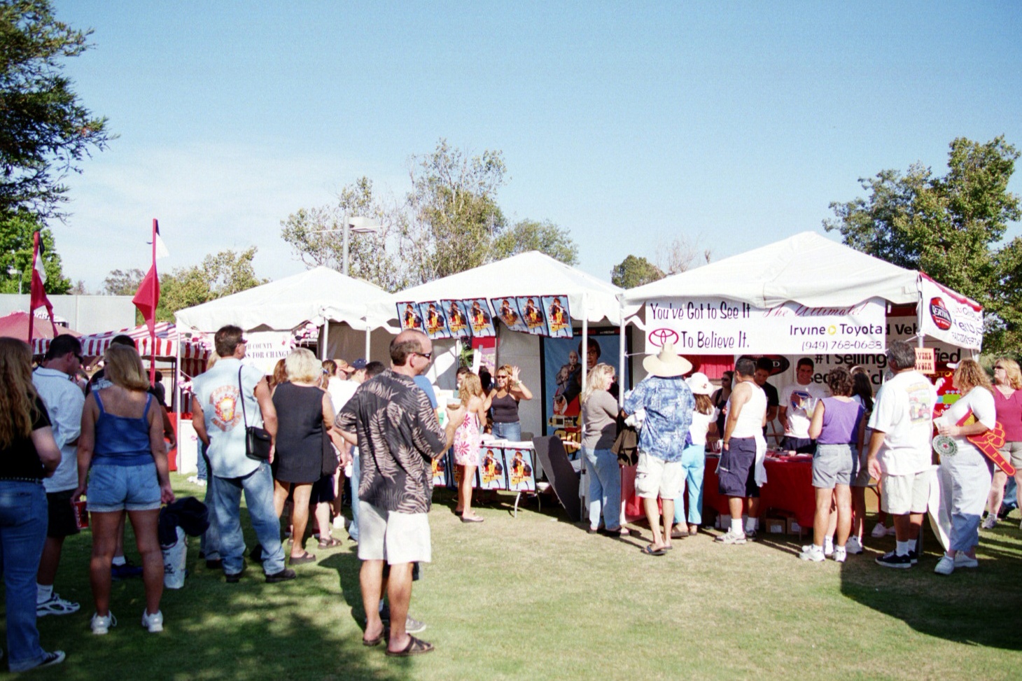 A group of people standing in front of a tent.