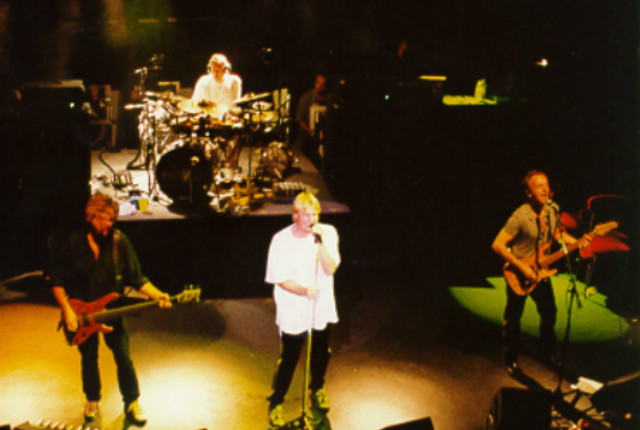 A group of people on stage with a microphone.