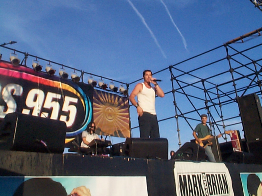 A man is singing on stage at a concert.