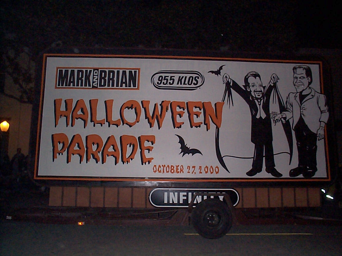 A billboard for halloween parade advertising the event.