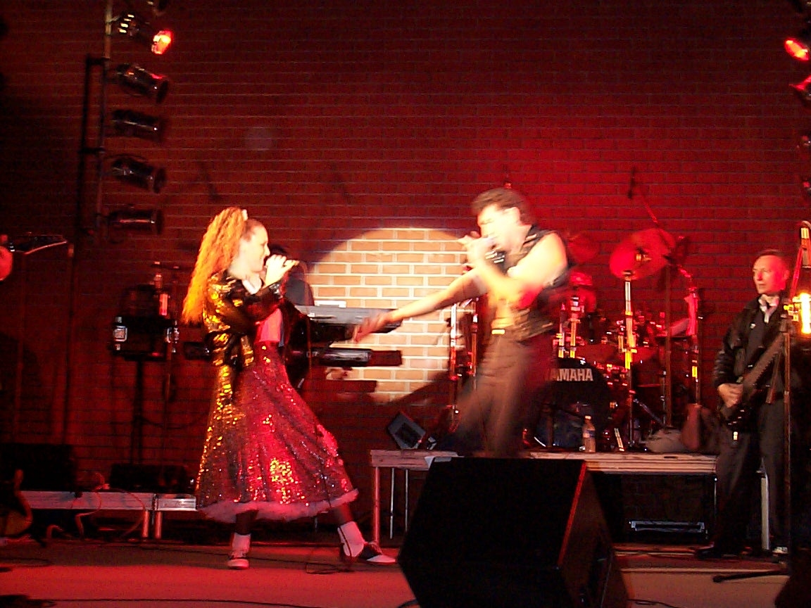 A man and woman performing on stage.