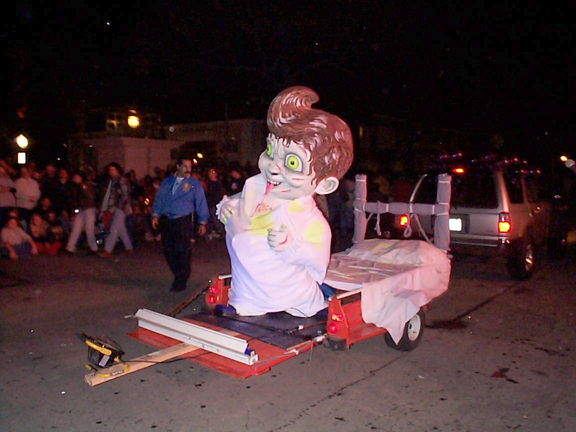 A parade float with a person in costume on it.