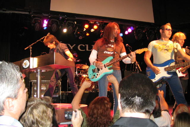 A group of people playing instruments on stage.