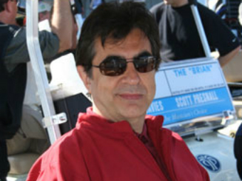 A person wearing sunglasses and red shirt