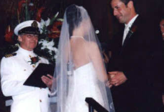 A bride and groom are standing together at their wedding.