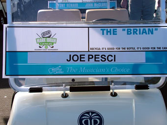 A billboard for the joe pesci show on the side of a building.