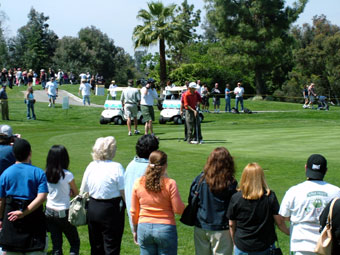 A group of people standing on top of a green.