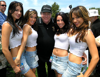 A group of girls posing with an officer.