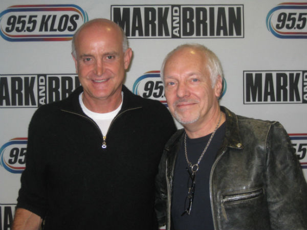 Two men standing next to each other on a red carpet.