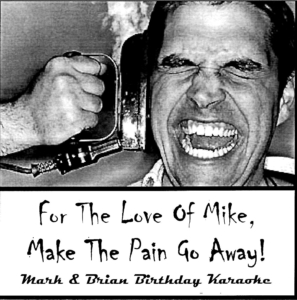 A man holding a phone and laughing.